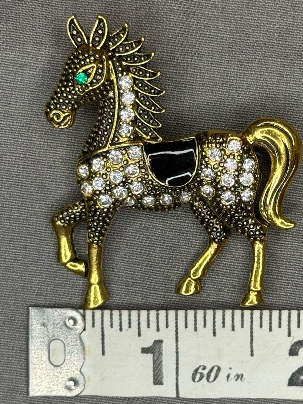 Gold Tone Horse Brooch with Clear Rhinestones and Black Enamel Saddle
